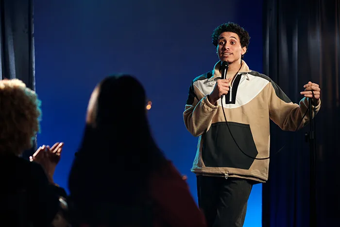 a comedian performs for a crowd